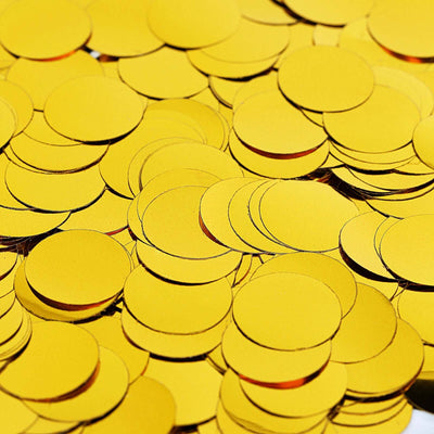 Yellow paper circles scattered on a surface.