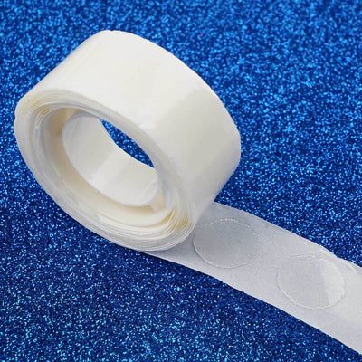 Clear adhesive tape roll on a blue glitter background.