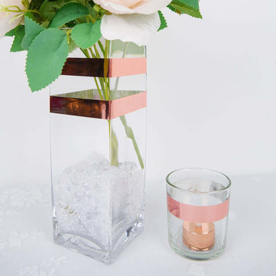 Glass vase with decorative strips and a candle holder on a white background.