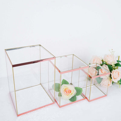 Elegant glass display boxes with rose gold accents and artificial flowers