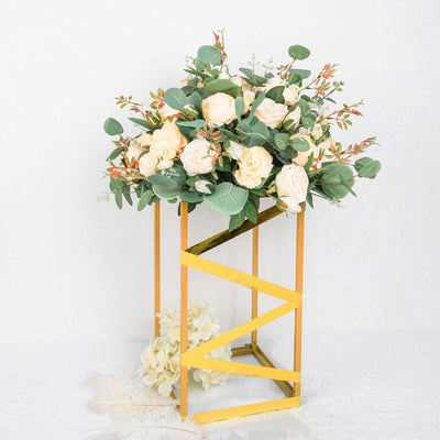 Artificial floral arrangement in a yellow stand with roses and greenery.