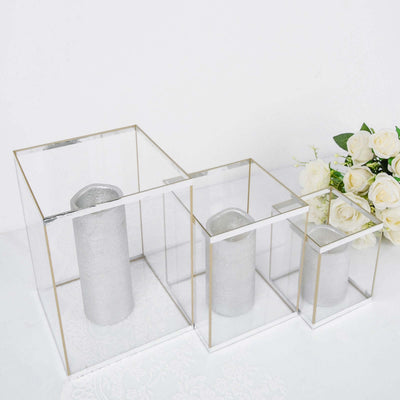 Silver candle holders in geometric glass frames with gold accents