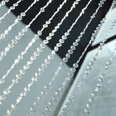 Crystal bead curtain strands shimmering in light.