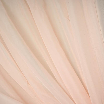 Soft peach sheer fabric draping elegantly.