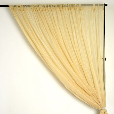 Sheer beige curtain draped elegantly on a rod