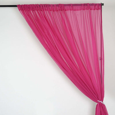 Pink sheer curtain draping elegantly on a black rod.