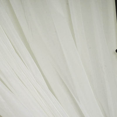 Sheer white fabric drapes elegantly in soft folds.