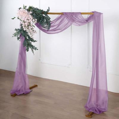 Purple drapery with floral arrangement for event decoration.