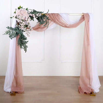 Wedding arch with draped fabric and floral accents.