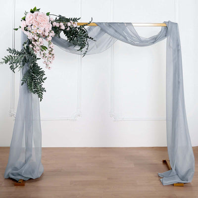 Wedding arch with draped fabric and floral arrangement.