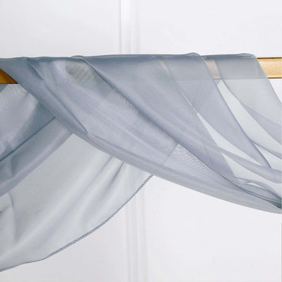 Sheer gray fabric draped elegantly on a wooden rod.