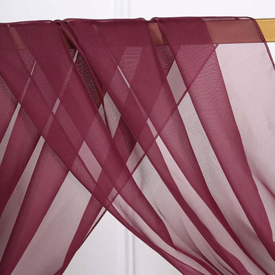 Burgundy sheer curtain fabric draped elegantly on a rod