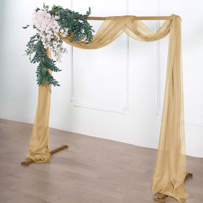 Elegant floral wedding arch with draped fabric and greenery.