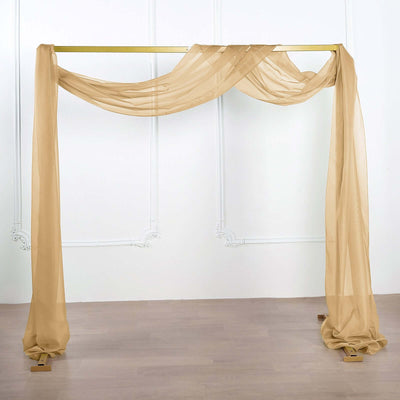 Elegant sheer fabric drapery over a gold wedding arch