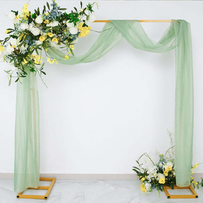 Floral arch with green drapes and yellow flowers on a wooden frame