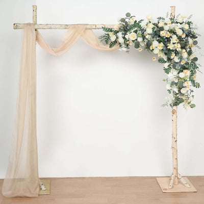 Wooden wedding arch adorned with flowers and drapes.