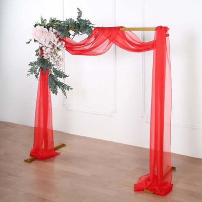 Red floral draped wedding arch on a plain background.