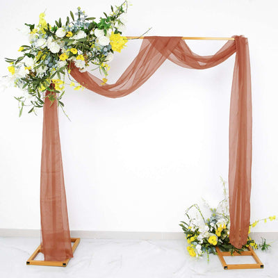 Floral wedding arch with draped fabric and decorative flowers