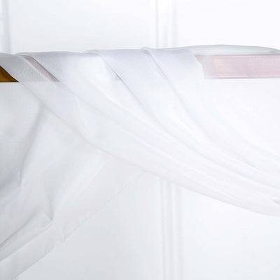 Sheer white fabric draped elegantly on a wooden rod