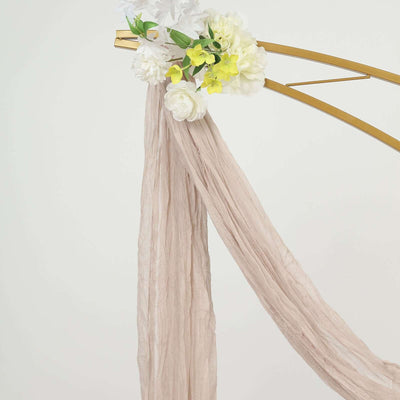 Beige textured fabric draped with floral accents on a gold frame.
