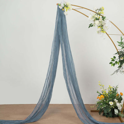 Blue sheer fabric draped elegantly with floral arrangements.