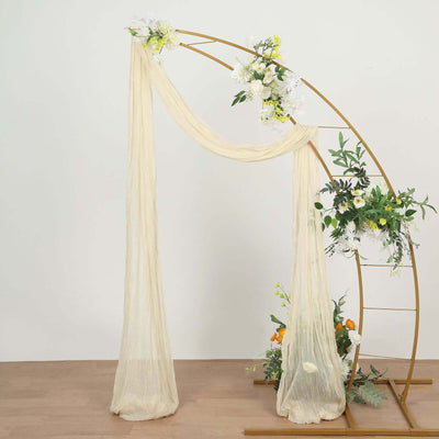 Elegant wedding arch with draped fabric and floral arrangements.