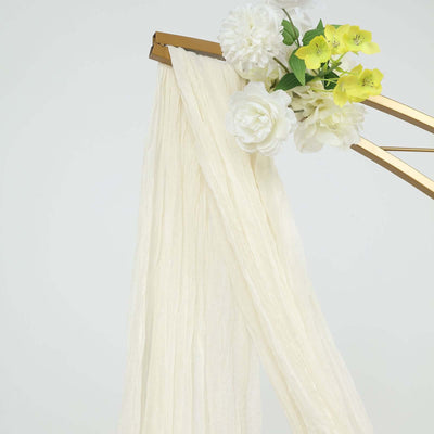 Ivory fabric drape with artificial flowers on a gold frame