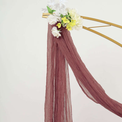 Maroon drapery with floral accents on a gold arch