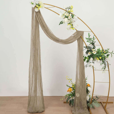 Elegant sheer drapery on a floral arch for weddings and events