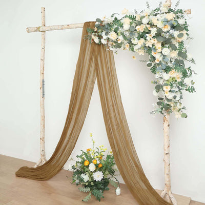 Floral backdrop with draped fabric and wooden structure for events or photography.