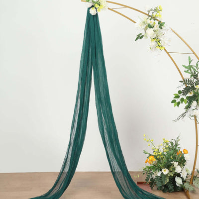 Green chiffon drapery hanging elegantly with floral accents