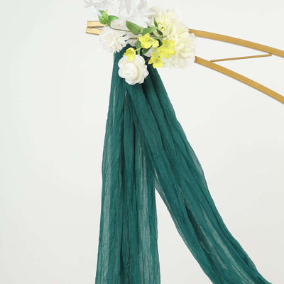 Green chiffon scarf draped elegantly with white and yellow flowers