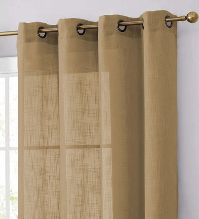 Sheer beige curtains with grommets hanging on a decorative rod