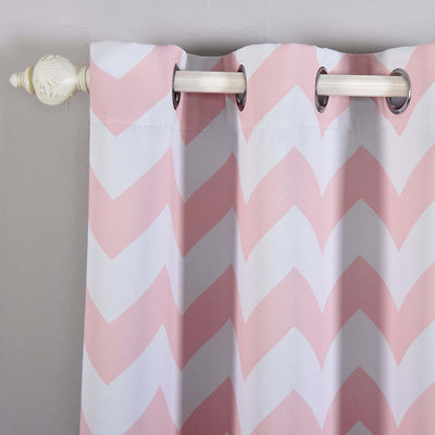 Pink chevron pattern curtain with grommets hanging on a rod.