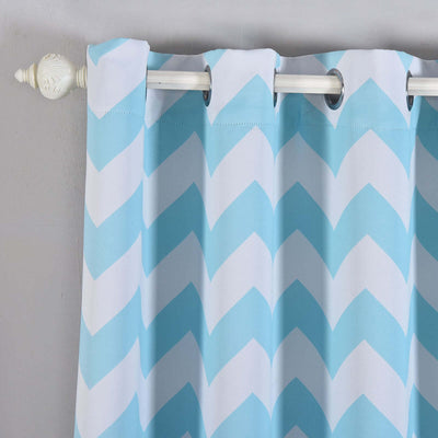 Blue and white chevron patterned curtain hanging on a rod.