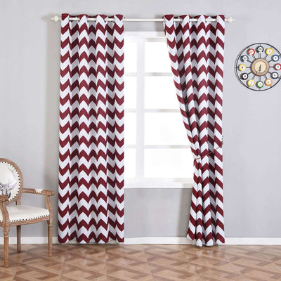 Chevron pattern curtains in burgundy and white hanging in a stylish room.
