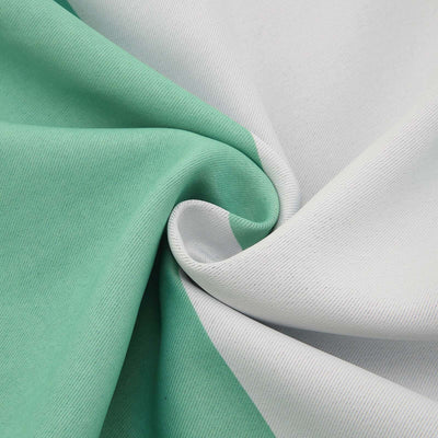 Green and white fabric close-up showing texture and folds.