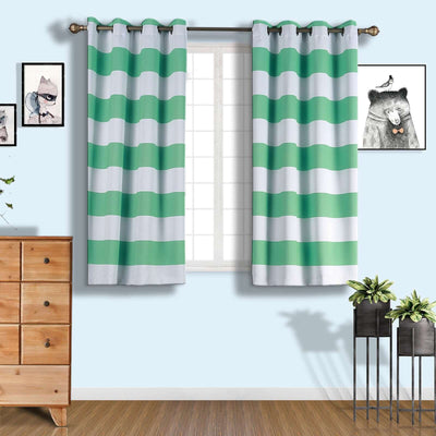 Green and white striped curtains hanging in a light blue room with decor.