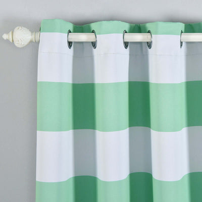 Green and white striped curtain with grommets hanging on a rod.