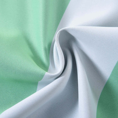 Green and white fabric with a smooth texture, showcasing its draping quality.