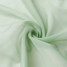 A close up of a swirl of light green chiffon fabric ceiling drapes, sheer backdrops, and sheer curtains#whtbkgd