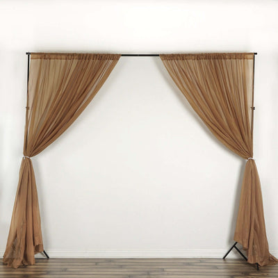 Sheer brown curtains draped elegantly on a black frame.