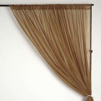 Sheer brown curtain draped elegantly on a rod.