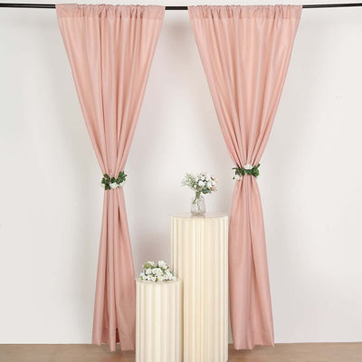 Blush pink curtains draped elegantly with floral ties in a studio setting.