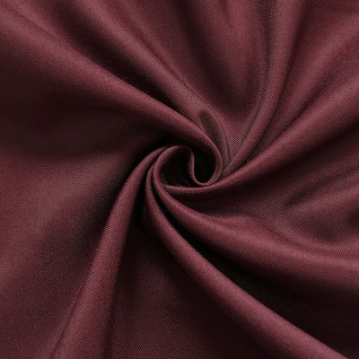 Burgundy fabric in a swirling pattern showcasing texture and depth.