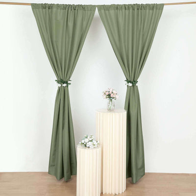 Green curtains styled with floral ties, draped elegantly in a cozy setting.