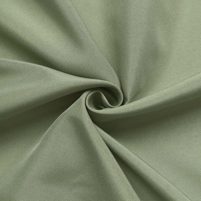Soft green fabric texture in a swirling pattern.