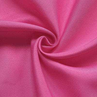 Close-up of vibrant pink fabric showcasing its texture and sheen.