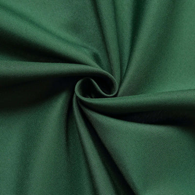 Green fabric texture in a swirl pattern.