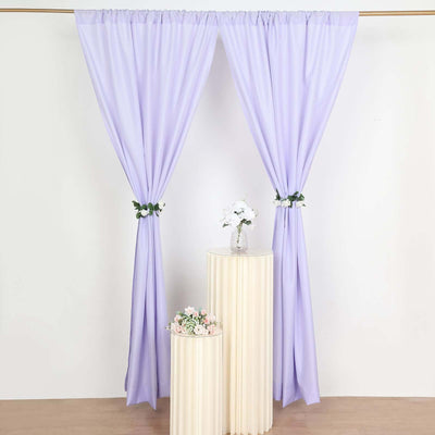 Lavender curtains with floral accents draped elegantly in a studio setting.